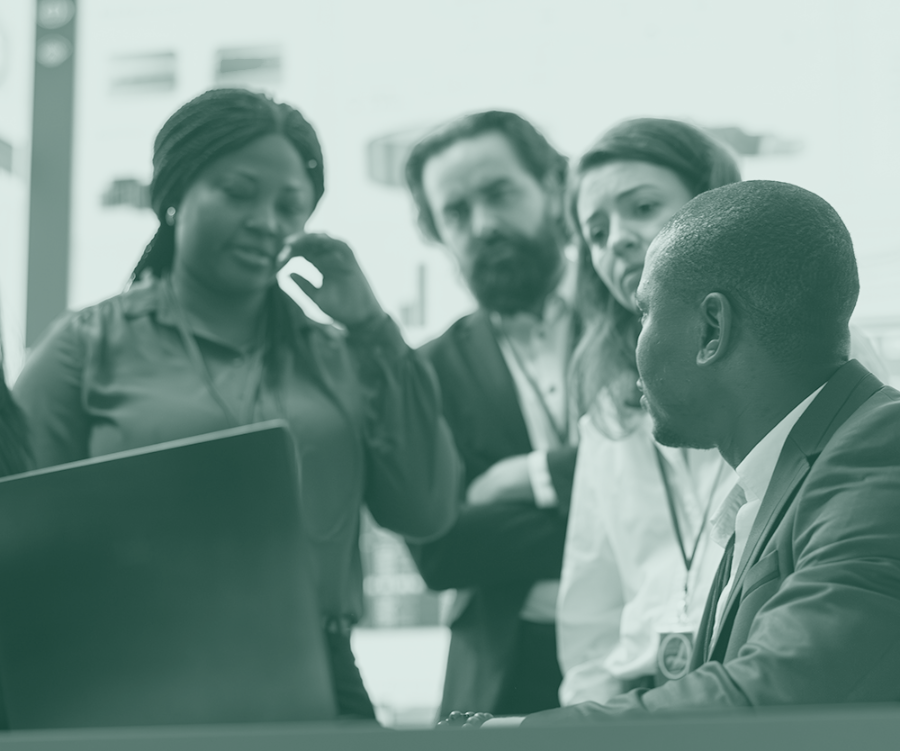 Colleagues in discussion around a laptop